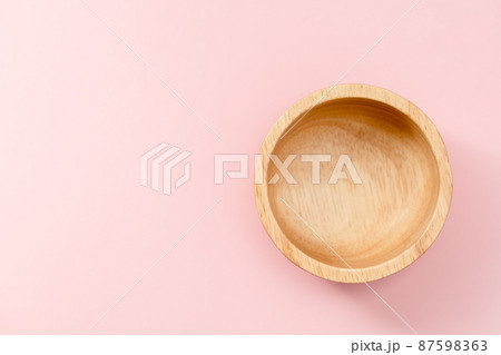 Wooden bowl on pink background 87598363