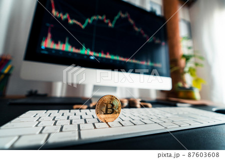 Crypto coins and graphs in the computer screen 87603608