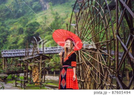 A female tourist dressed in the traditional dress of the inhabitants of the Vietnamese mountains, the Hmong. Woman in Sapa in the fog, Northwest Vietnam. Vietnam travel concept. UNESCO heritage A female tourist dressed in the traditional dress of the inhabitants of the Vietnamese mountains, the Hmong. Woman in Sapa in the fog, Northwest Vietnam. Vietnam travel concept. UNESCO heritage 87605494