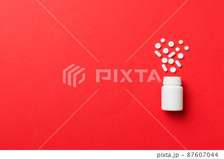 Multicolored pills and capsules in plastic bottle on Colored background, copy space. Many different various medicine tablets and pills, vitamin and nutritional supplements concept Multicolored pills and capsules in plastic bottle on Colored background, copy space. Many different various medicine tablets and pills, vitamin and nutritional supplements concept 87607044
