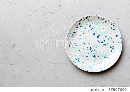 Top view of empty colorful plate on cement background. Empty space for your design 87607060
