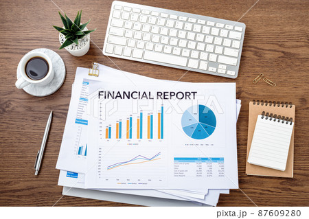 Business financial report, stack of chart graph and accounting data documents with computer on office wooden desk, financial statement review 87609280