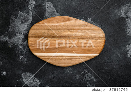 Empty cutting board, on black dark stone table background, top view flat lay , with copy space for text or your product 87612746