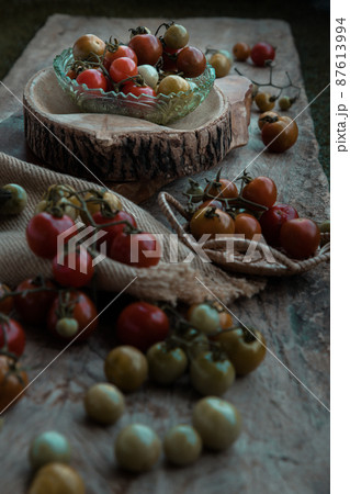 Group of Colorful variety of Fresh wild tomatoes (Mini Cherry Tomatos) on old wooden board background. 87613994
