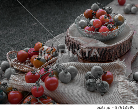 Group of Colorful variety of Fresh wild tomatoes (Mini Cherry Tomatos) on old wooden board background. 87613996