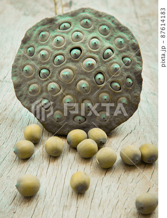 Fresh green lotus seed pods and Lotus seeds green on old wooden board background. 87614183