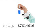 Holding test tube with blue liquid. 87614616