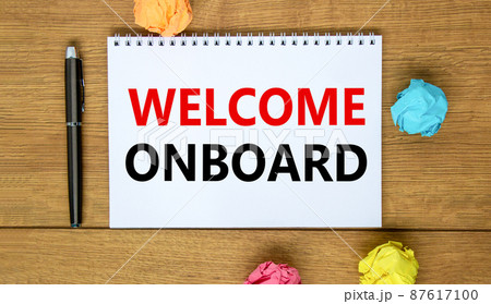 Welcome onboard and support symbol. Concept words Welcome onboard on white note. Metallic pen. Beautiful wooden background. Copy space. Business and Welcome onboard concept. 87617100