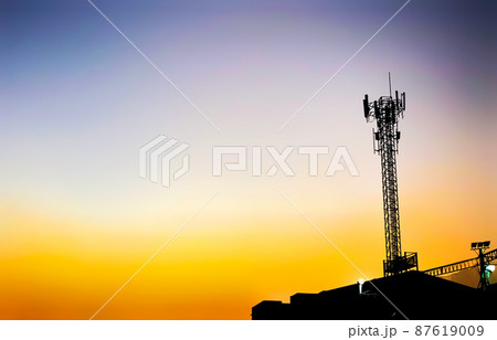 The silhouette of a telephone communication tower in the evening with a beautiful orange sky. The silhouette of a telephone communication tower in the evening with a beautiful orange sky. 87619009