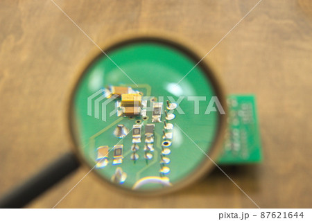 Printed circuit board under a magnifying glass 87621644