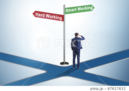 Businessman at the crossroads on working smart or hard Businessman at the crossroads on working smart or hard 87627632