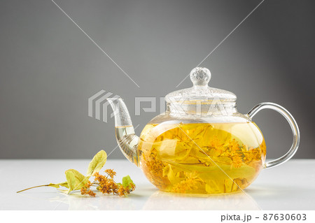 Linden or tilia tea in the transparent tea pot Linden or tilia tea in the transparent tea pot 87630603