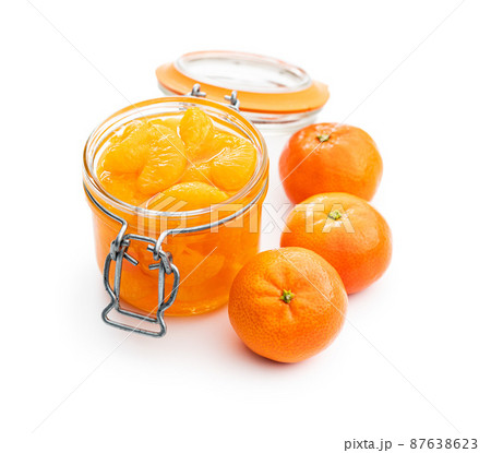 Canned tangerine. Pickled mandarin fruit in jar isolated on white background. Canned tangerine. Pickled mandarin fruit in jar isolated on white background. 87638623