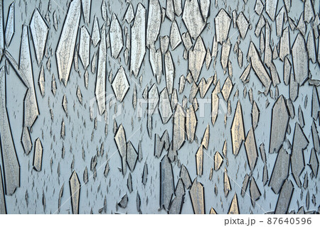 Detail of paint peeling off of a metal surface 87640596