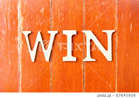 Alphabet letter in word win on old red color wood plate background 87645939