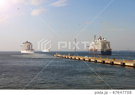 Cruise ship liner goes into horizon the blue sea leaving port. water seascape concept of sea travel 87647708
