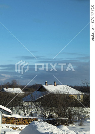 Winter in village on turn blue background Winter in village on turn blue background 87647710