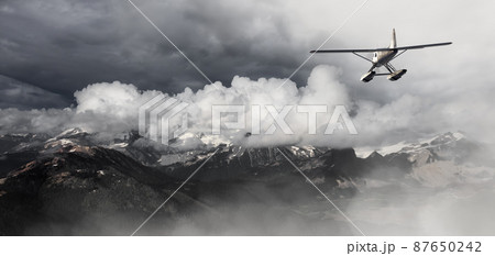 Single Engine Seaplane Flying over the Rocky Mountain Landscape Single Engine Seaplane Flying over the Rocky Mountain Landscape 87650242
