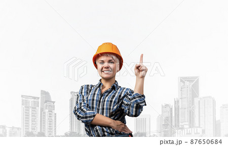Beautiful female builder in hardhat 87650684