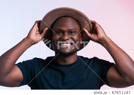 Smiling happy american african man wear stylish hat on white background. Festive and party concept 87651187