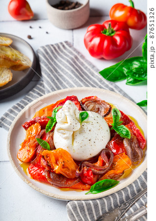 Burrata cheese with baked tomatoes, pepper, red onion and fresh Burrata cheese with baked tomatoes, pepper, red onion and fresh 87651326
