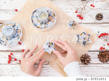 The woman's hands make food for wild birds from lard and seeds, millet, in foil molds.  87651651