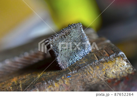 Metal magnet in the iron crumb in the hands 87652264