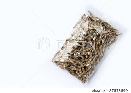 Dried anchovy in plastic bag on white background 87653640