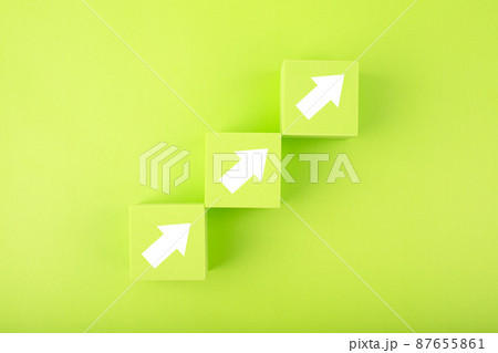 Ladder career, sales or business growth path concept. Green toy cubes as step stairs with white arrows up  87655861