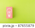 Creativity, innovation and idea concept. Light bulb drawn on pink rectangle on bright green background with copy space 87655879