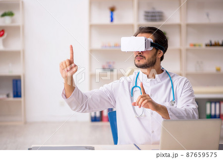 Young male doctor wearing virtual glasses 87659575