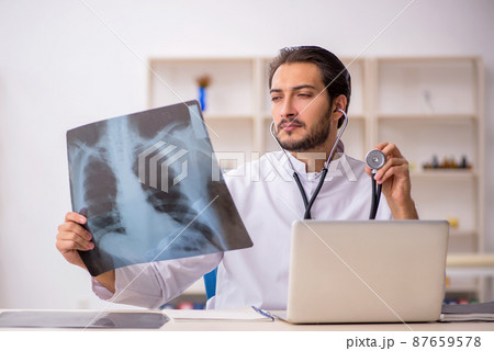 Young male doctor radiologist working in the clinic Young male doctor radiologist working in the clinic 87659578