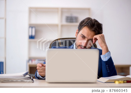 Young male employee working in the office 87660345