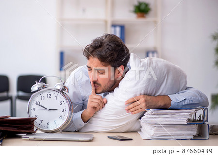 Young male employee in oversleeping concept Young male employee in oversleeping concept 87660439