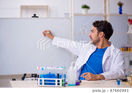 Young male chemist working at the lab 87660983