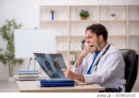 Young male doctor radiologist working in the clinic 87661010