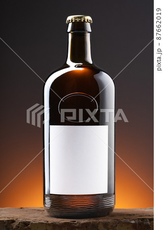Blank label on the beer bottle on dark background. 87662019