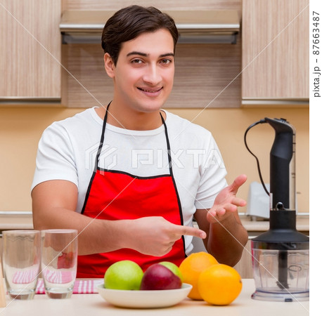 Handsome man working at the kitchen 87663487