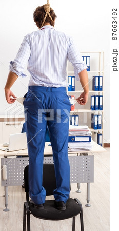 The desperate businessman thinking of committing suicide hanging 87663492