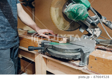 Framing Workshop. Sawing circular saw baguette handmade picture frame Framing Workshop. Sawing circular saw baguette handmade picture frame 87664528