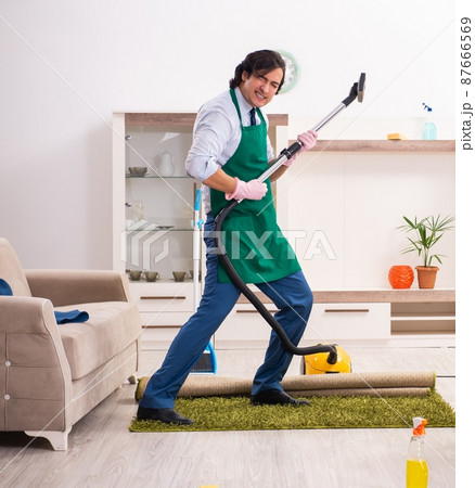 Young businessman cleaning the house Young businessman cleaning the house 87666569