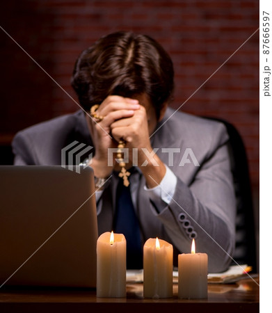 The businessman working late in office with candle light The businessman working late in office with candle light 87666597