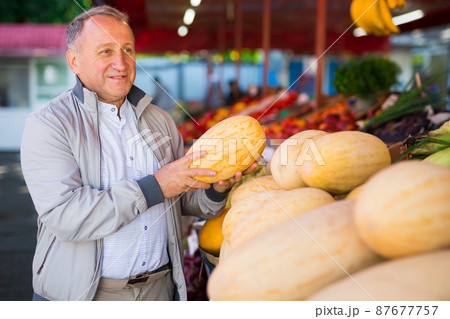 Middle aged man buying melon 87677757