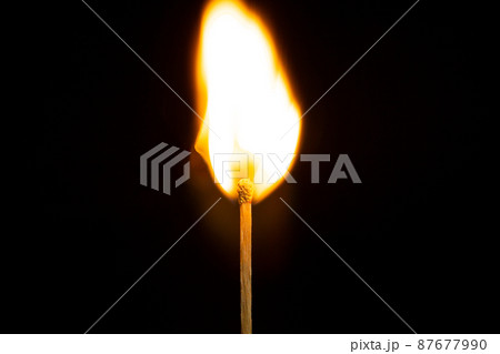 close up Single matchstick burning isolated on black background. 87677990