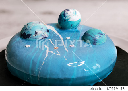 Blue mousse cake with blue chocolate balls 87679153