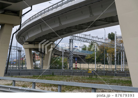 Car overpass over the railroad tracks in the city. 87679393