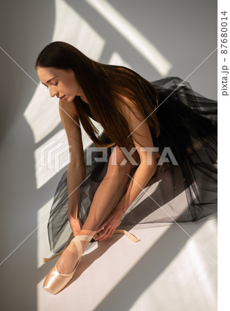 Ballerina ties the ribbons on ballet shoes. Ballerina ties the ribbons on ballet shoes. 87680014