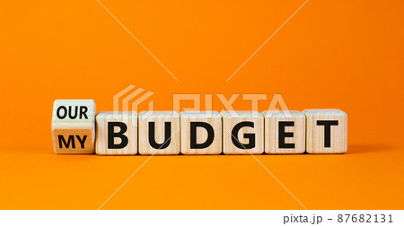 Turned a cube and changed the words 'our budget' to 'my budget' or vice versa. Beautiful orange background. Business concept. Copy space. Turned a cube and changed the words 'our budget' to 'my budget' or vice versa. Beautiful orange background. Business concept. Copy space. 87682131