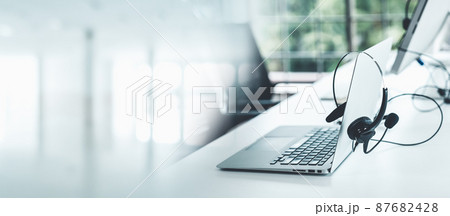 Headset and customer support equipment at call center ready for actively service Headset and customer support equipment at call center ready for actively service 87682428
