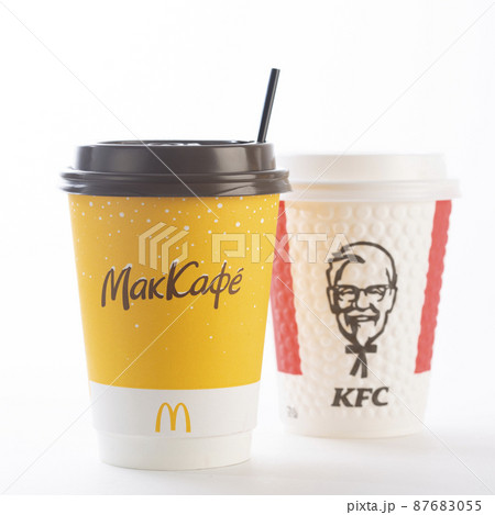 St. Petersburg, Russia - March 13, 2022: Paper cup from McDonald's and KFC out on a white background. McDonald's and KFC is leaving Russia. The inscription on the cup McCafe. isolated St. Petersburg, Russia - March 13, 2022: Paper cup from McDonald's and KFC out on a white background. McDonald's and KFC is leaving Russia. The inscription on the cup McCafe. isolated 87683055